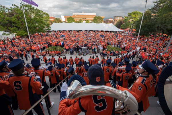 People dressed in orange on the quad.