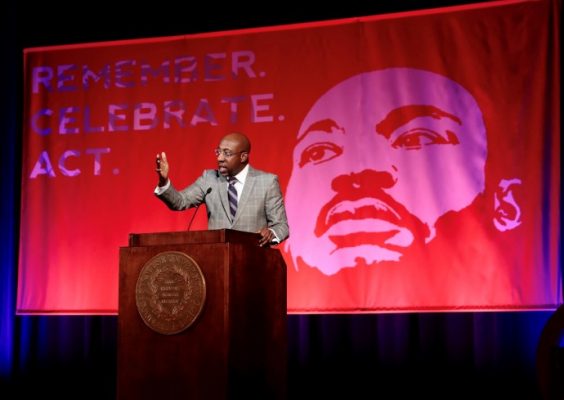 Rev. Raphael Warnock speaks at podium