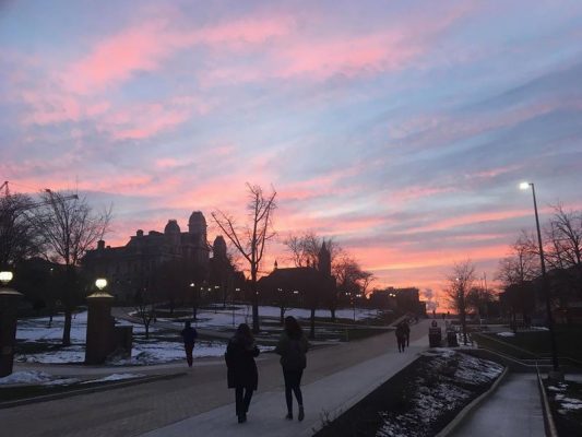 people walking on campus at dusk