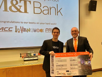 two people holding giant check