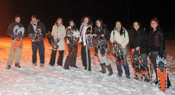 Group of students posing with snowshoes