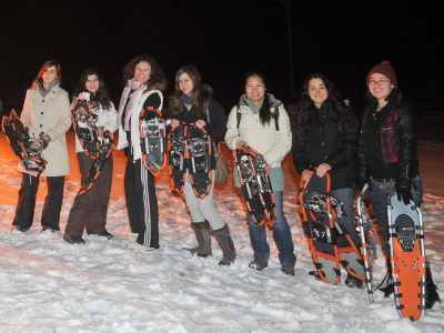 group of students holding snowshoes