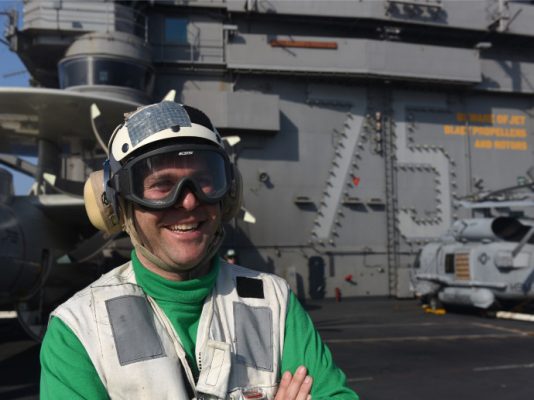 person on deck of navy ship