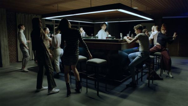 video still of people gathered in a bar