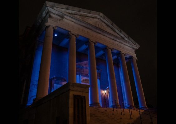 Hendricks chapel main entrance at night lit in blue color.