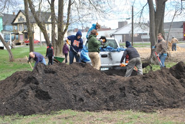 people working in compost pile