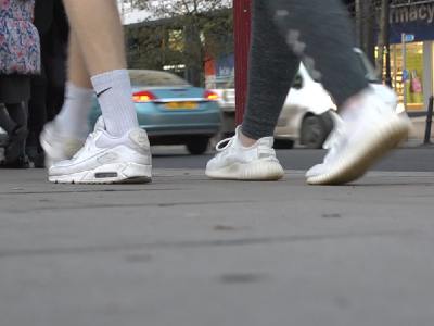 People's feet walking on pavement