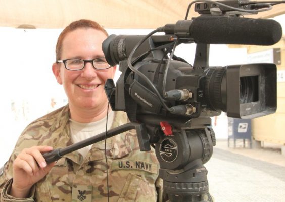 woman in uniform with video camera