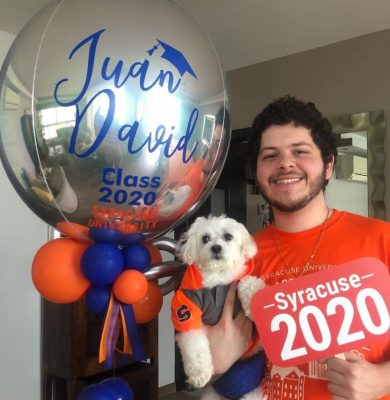 person holding dog, ballons and Syracuse University decorations