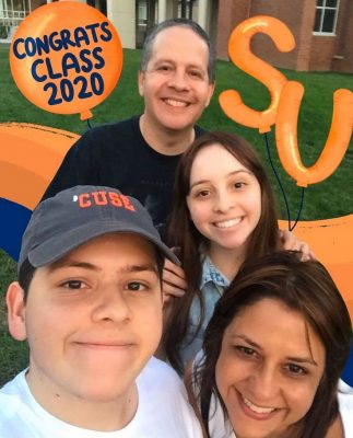 family members next to Syracuse University decorations