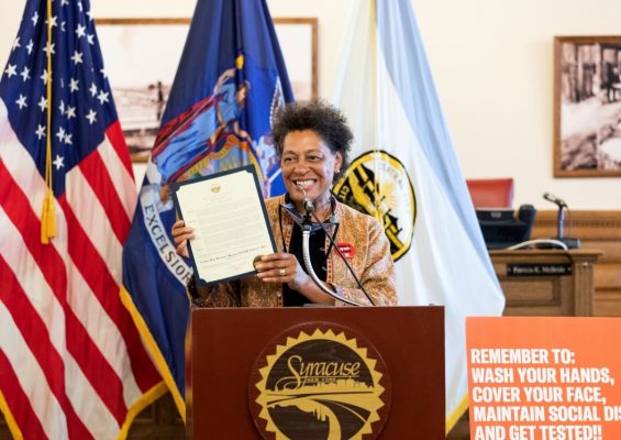 woman at podium holding a certificate