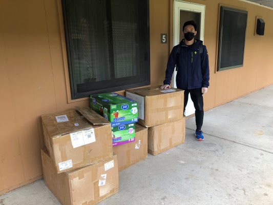 person standing next to boxes
