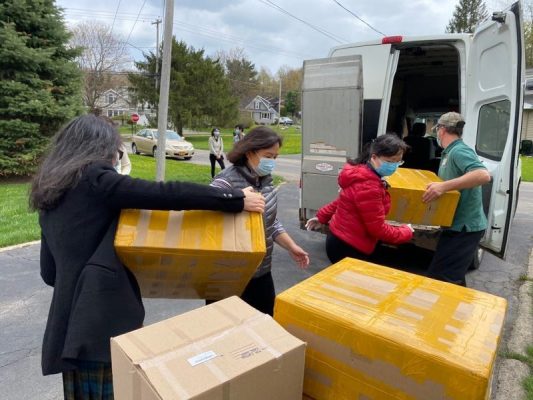 people loading boxes in vehicle