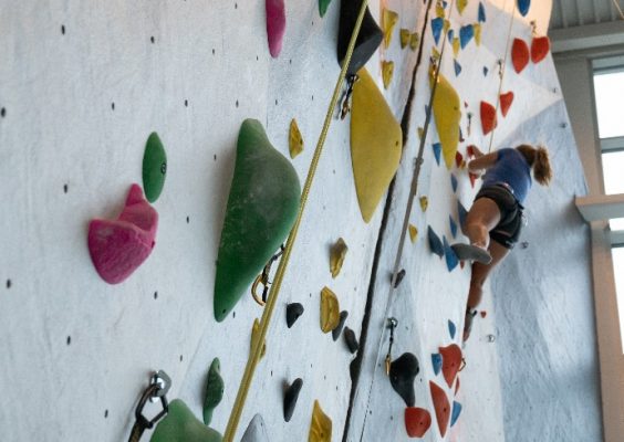 person utilizing rock climbing wall at the Barnes Center at The Arch