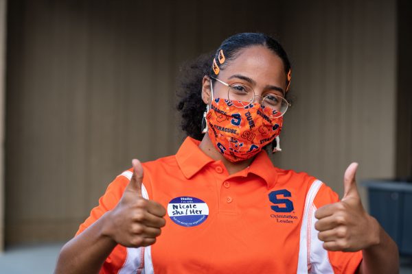 person wearing mask with thumps up