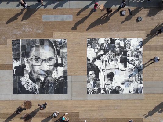 overhead view of two mosaic photos surrounded by students