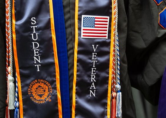 Graduation gown with "Student Veteran" on sash