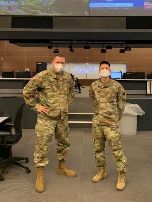 two people wearing military uniforms and wearing masks