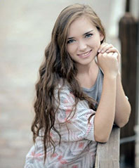 Hanna McNabb posing with her arms on a fence