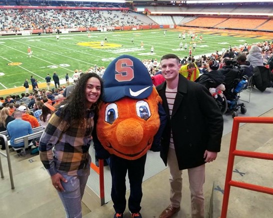 two people standing with Otto in stadium