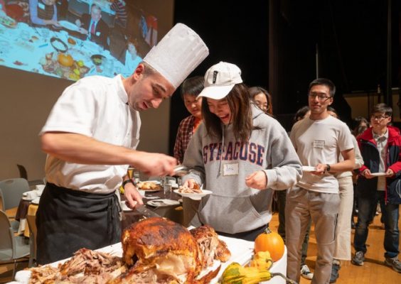 Staff member serving turkey to a student