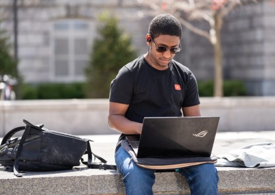 Student on laptop on the Quad