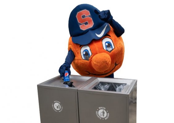 Otto places an empty bottle in the recycling bin