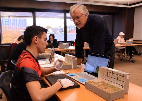 Religion professor James Watts collaborating with a student in the Special Collections Research Center