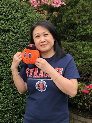 Sui, mom of Amanda Chau, poses in a Syracuse T-shirt with an Otto plush