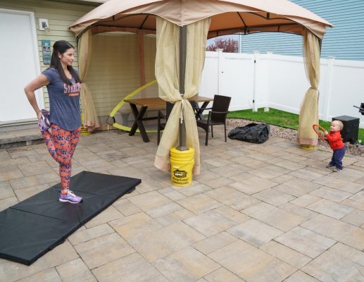 Kim DeStefano stretches while son Asher plays