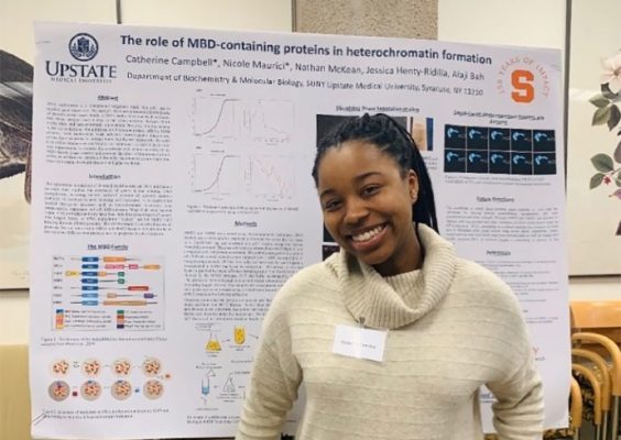 Catherine Campbell presents at a poster session in 2019