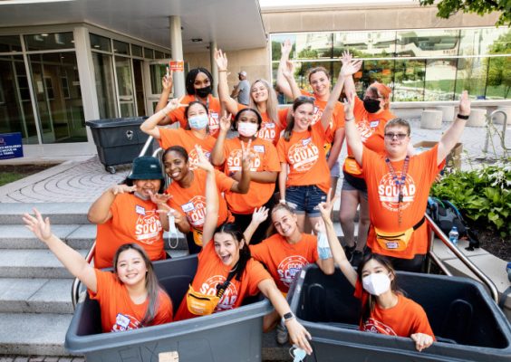 group of students in moving bins at residence halls