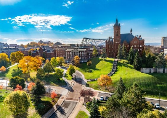 Campus buildings and grounds in peak Central New York fall colors. This is a photo looking south towards Hall of Languages and Crouse College with the new stadium roof crown visible from the roof of Crouse Hinds Hall