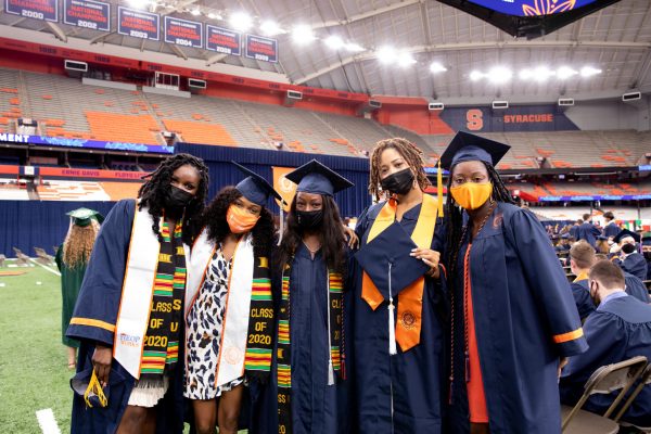 group of people in caps and gowns at 2020 Commencement, Sept. 19, 2021, in the stadium