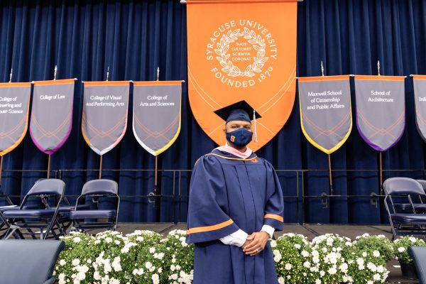 Kevin Richardson stands with hands folded in front of the stage at Commencement 2020