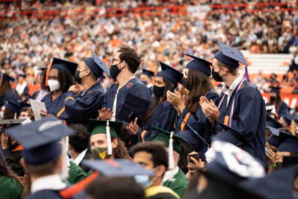 crowd of people with several standing and clapping at Commencement 2020