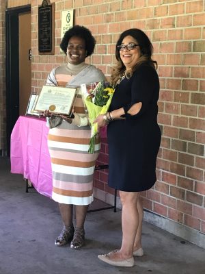Assemblywoman Pamela J. Hunter presents Clarise Shelby-Coleman with an award and bouquet of flowers