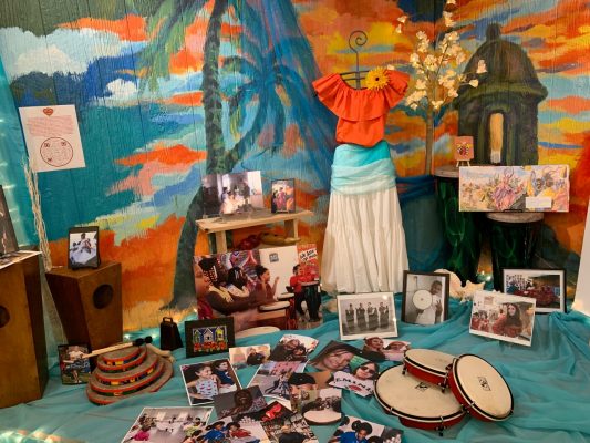a collection of objects on display during the 10th anniversary event of the La Casita Cultural Center