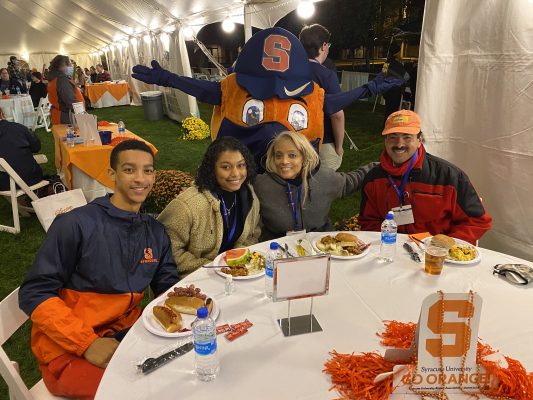 four people with Otto at Orange Central 2021 tailgate celebration