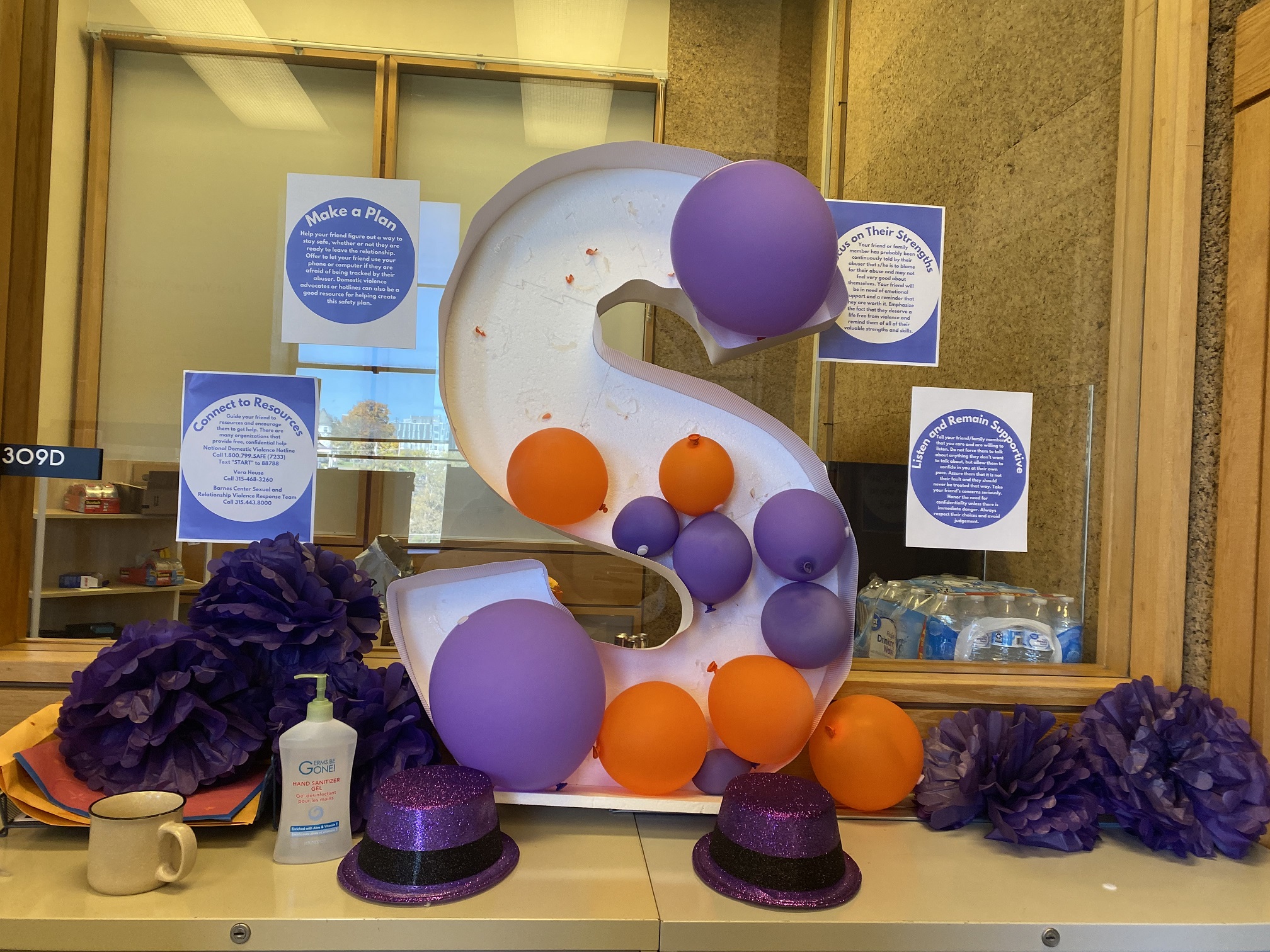 purple decorations on a counter with cut out block S
