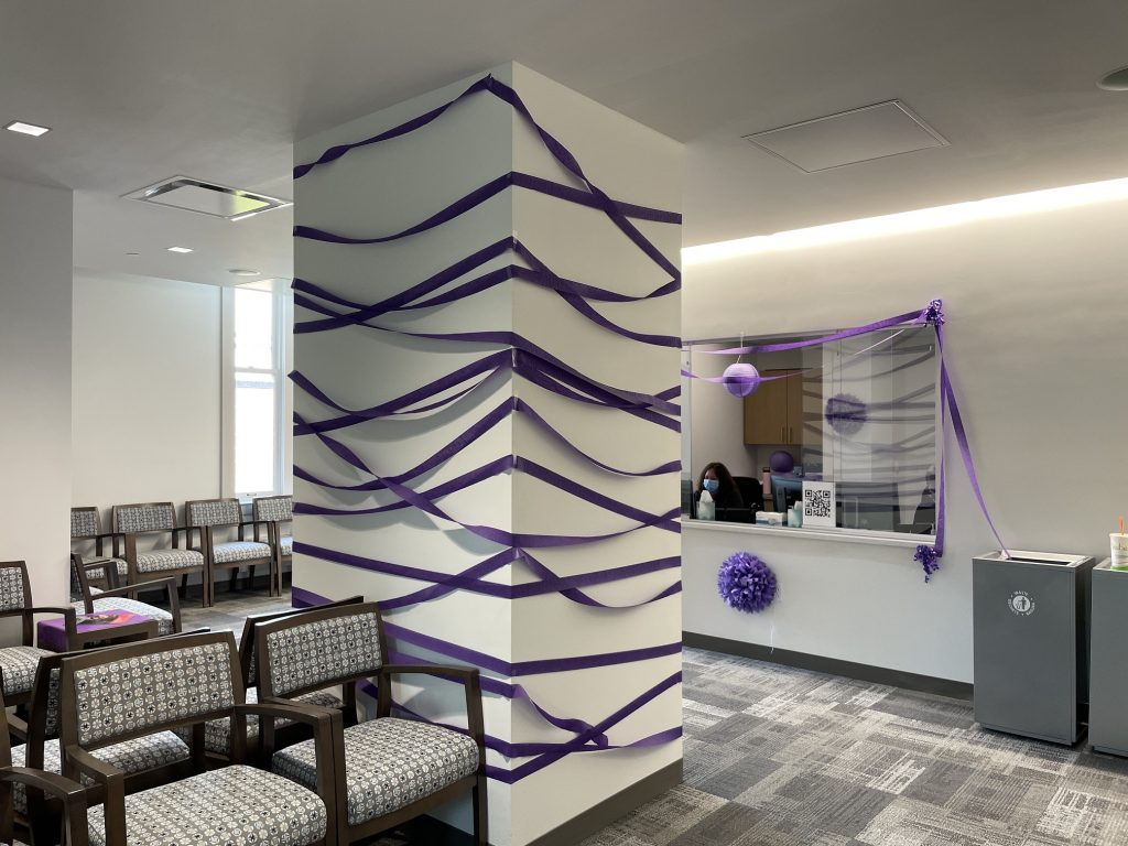 chairs in an office with column wrapped in purple streamer