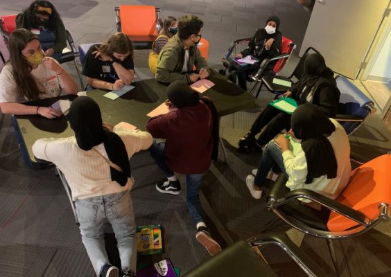 faculty and students working with youth from the North Side Learning Center during a storytelling workshop