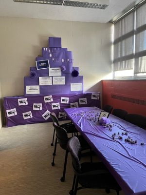 table covered in purple tablecloth and display of purple items