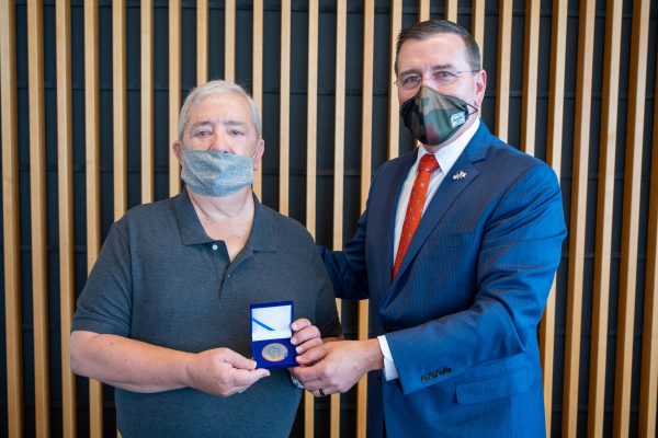 two people holding medal
