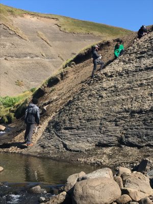 Professor and students searching for fossils