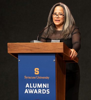 María D. Meléndez speaks at the podium during 2021 Alumni Awards at Orange Central