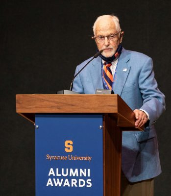 Russell King speaks from the podium at the 2021 Alumni Awards during Orange Central