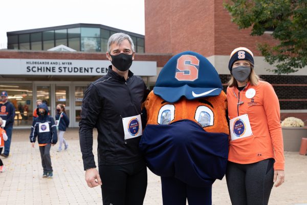 two people with Otto at the Race to Remember during Orange Central 2021