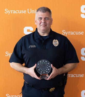 person in uniform holding award