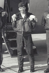 person in uniform standing in front of plane